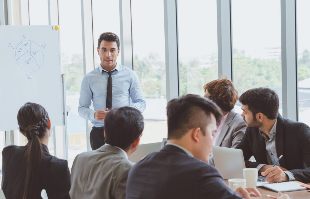Businessman leader presenting to work while meeting wiht colleag
